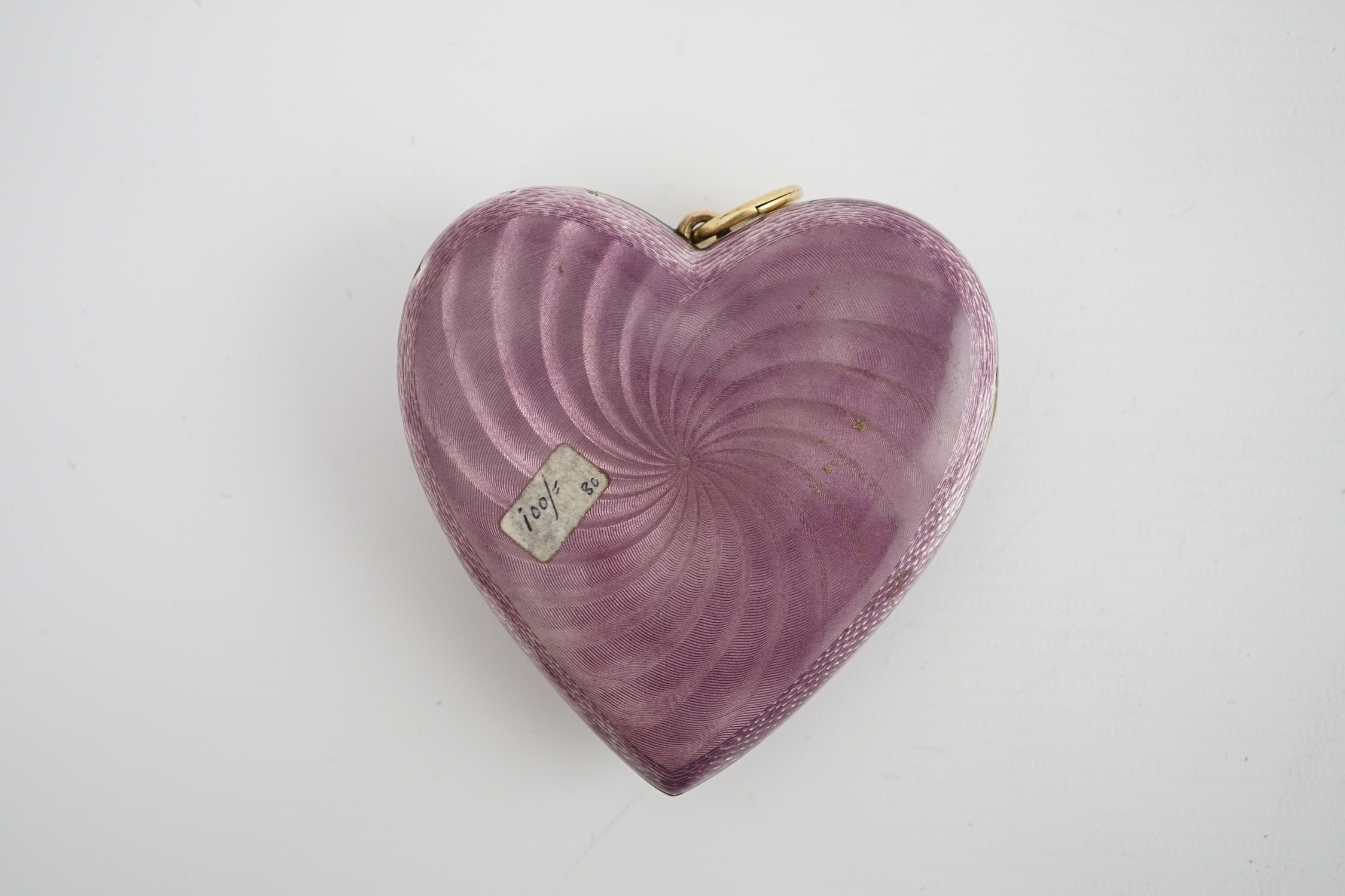 An Edwardian silver gilt? and guilloche enamel large heart shaped memorial locket